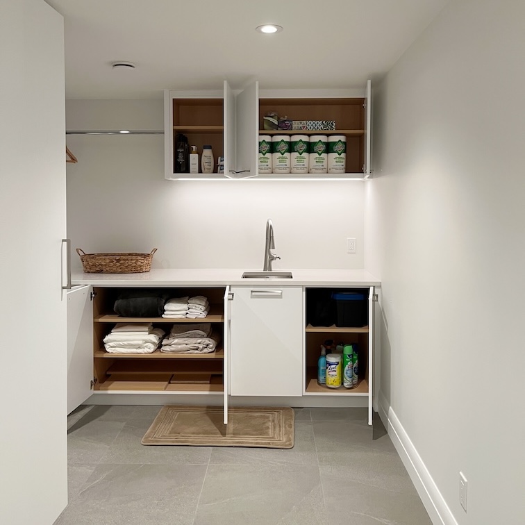 Professional laundry support in Calgary featuring a decluttered and organized laundry room with clear counters.
