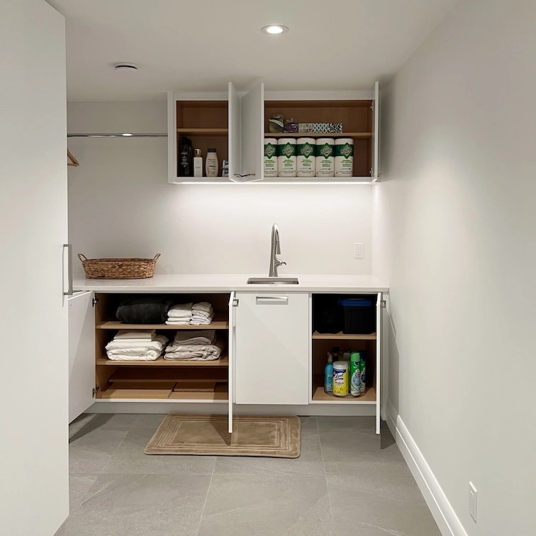 Professional laundry support in Calgary featuring a decluttered and organized laundry room with clear counters. 