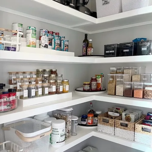 Walk-in pantry organization in a Mount Royal estate, featuring high-end storage systems and simplified living by Well Arranged Home.